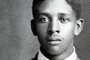 A portrait of Claude Devoyd Hall as a young man wearing a suit and bowtie