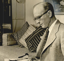 Lynn Riggs seated reading a book