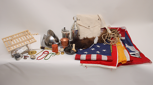 The Explorers trunk includes flags, a canvas haversack, beads, a lantern, and a Spanish-style helmet.