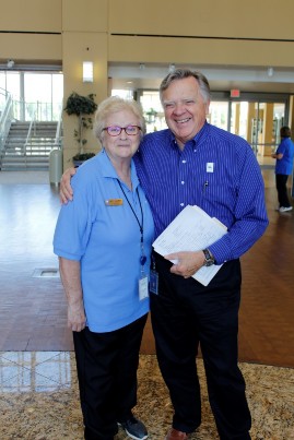 A staff member with his arm around the shoulder of a volunteer