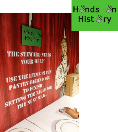 An exhibit with a green 'Hands on History' sign