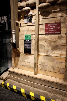 Exhibit featuring a wooden wall and a small trench