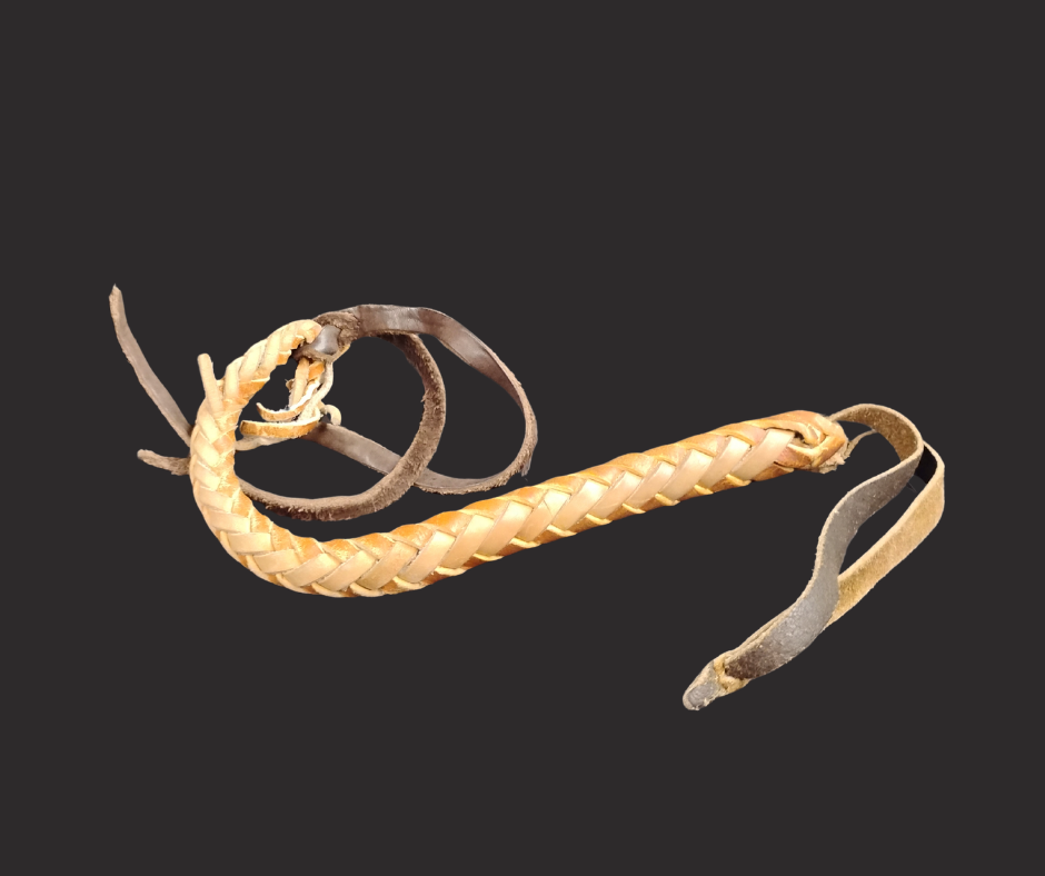 A quirt with a braided handle and three pieces of leather at the end.