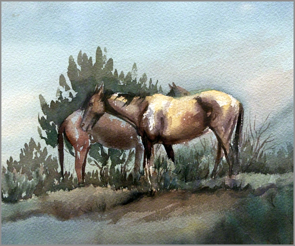 Two horses stand in front of a bush. They are facing in opposite directions.