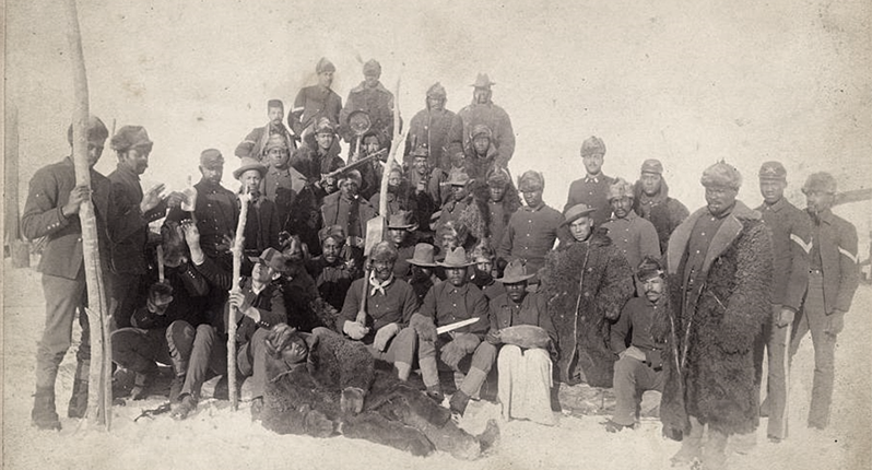 A large group of soldiers next to each other, many of them African American.